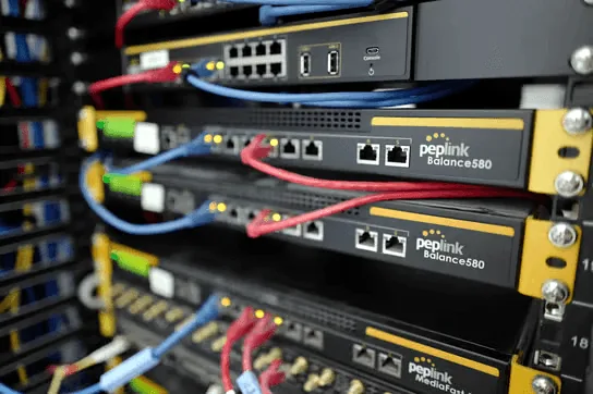 Peplink SD-WAN routers in a network rack