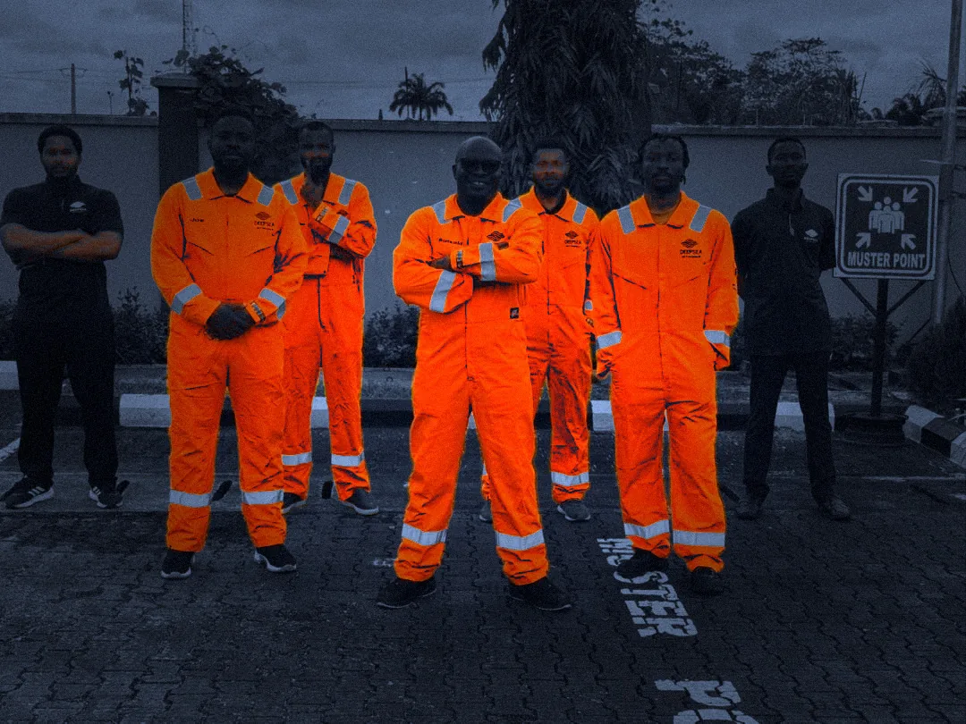 Deepsea field team in orange coveralls at the muster point