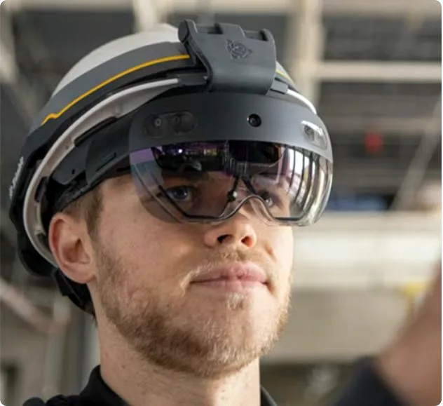 Engineer wearing a mixed reality headset under a hard hat