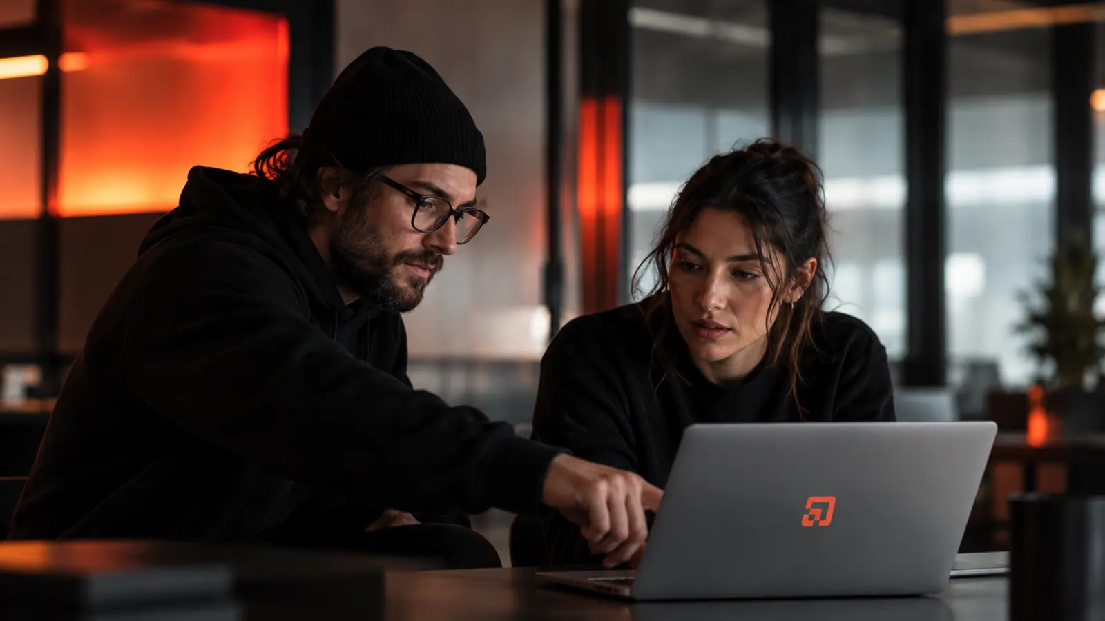 Two builders working together on a KORDIN laptop